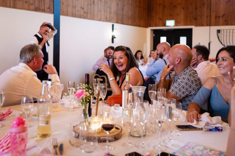 A wedding guest laughing at the best man's speech | Rose Dedman Photography | Bath Wedding Photographer