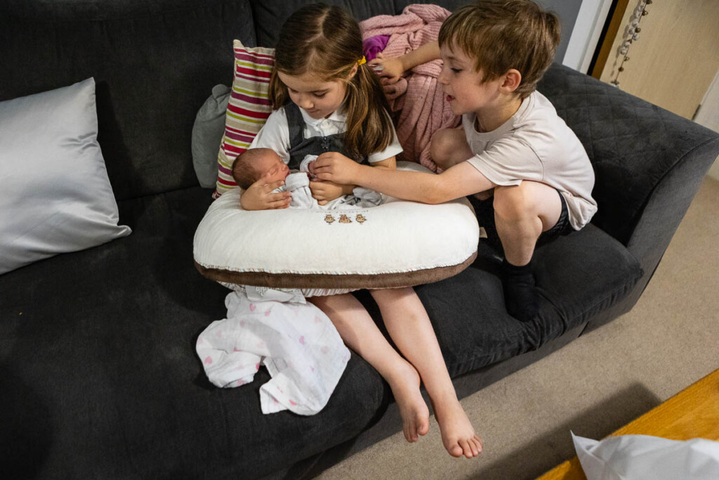 Photo of cuddles for new baby cousin | Bristol family portrait photographer