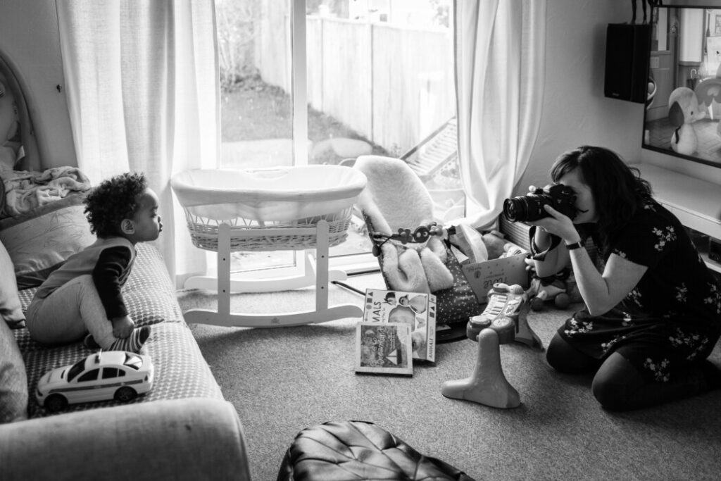 Photographer capturing toddler's candid moment at home