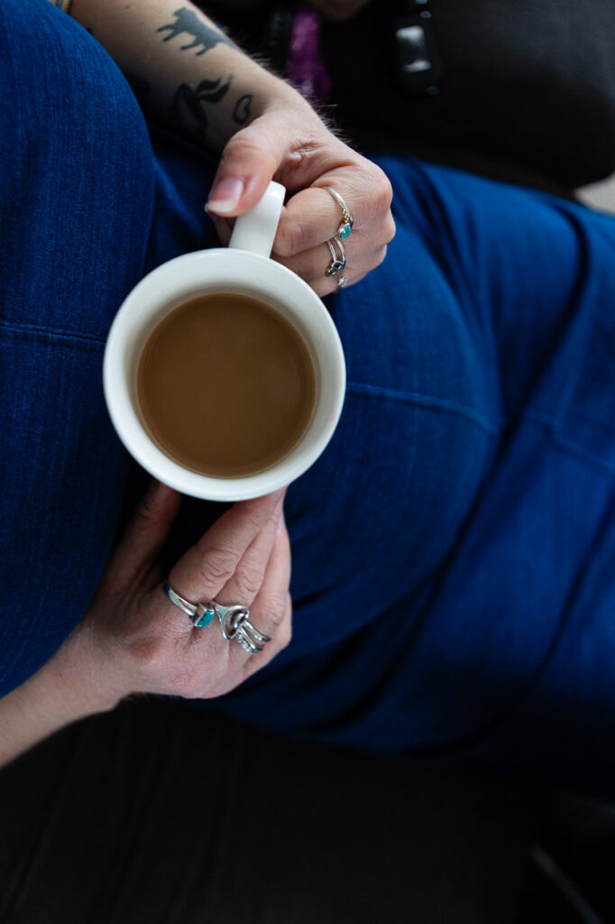 Person holding cup of tea, tattoos visible, wearing rings. Maternity photographer Bath Bristol | Rose Dedman