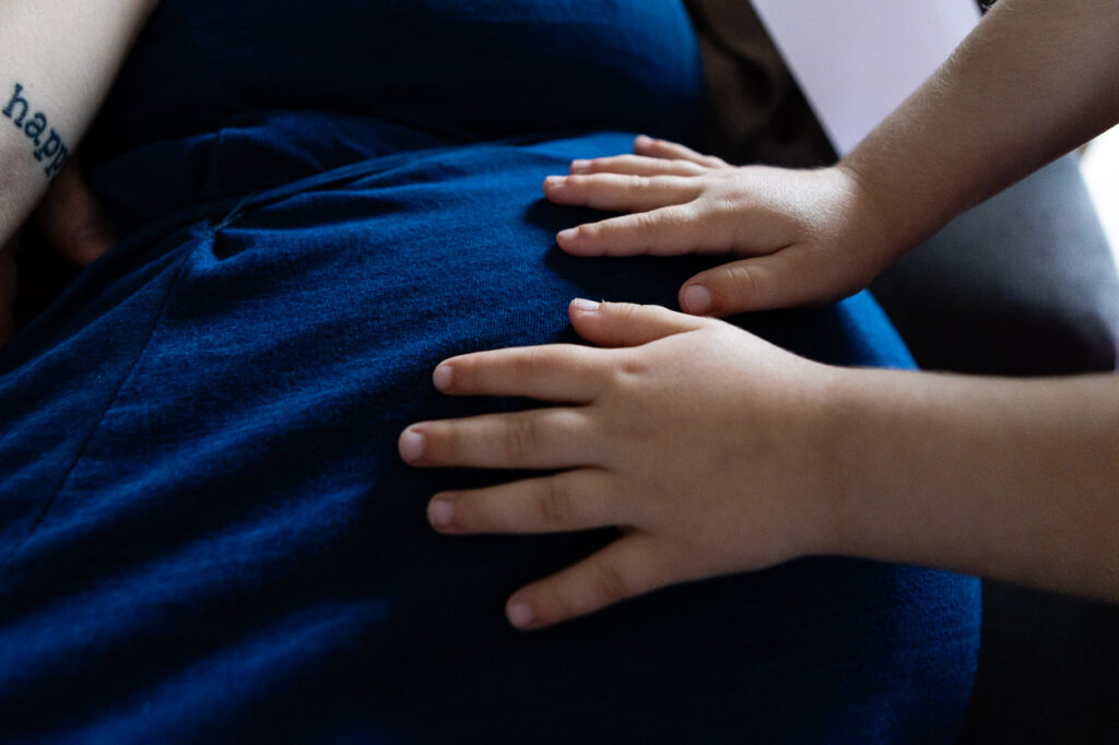 Child's hands on pregnant belly. Maternity Photographer Bath Bristol | Rose Dedman Photography
