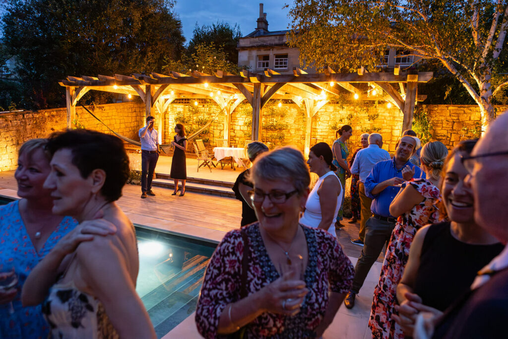 Outdoor evening party with guests and festoon lighting | Bath Bristol charity event photographer | Rose Dedman