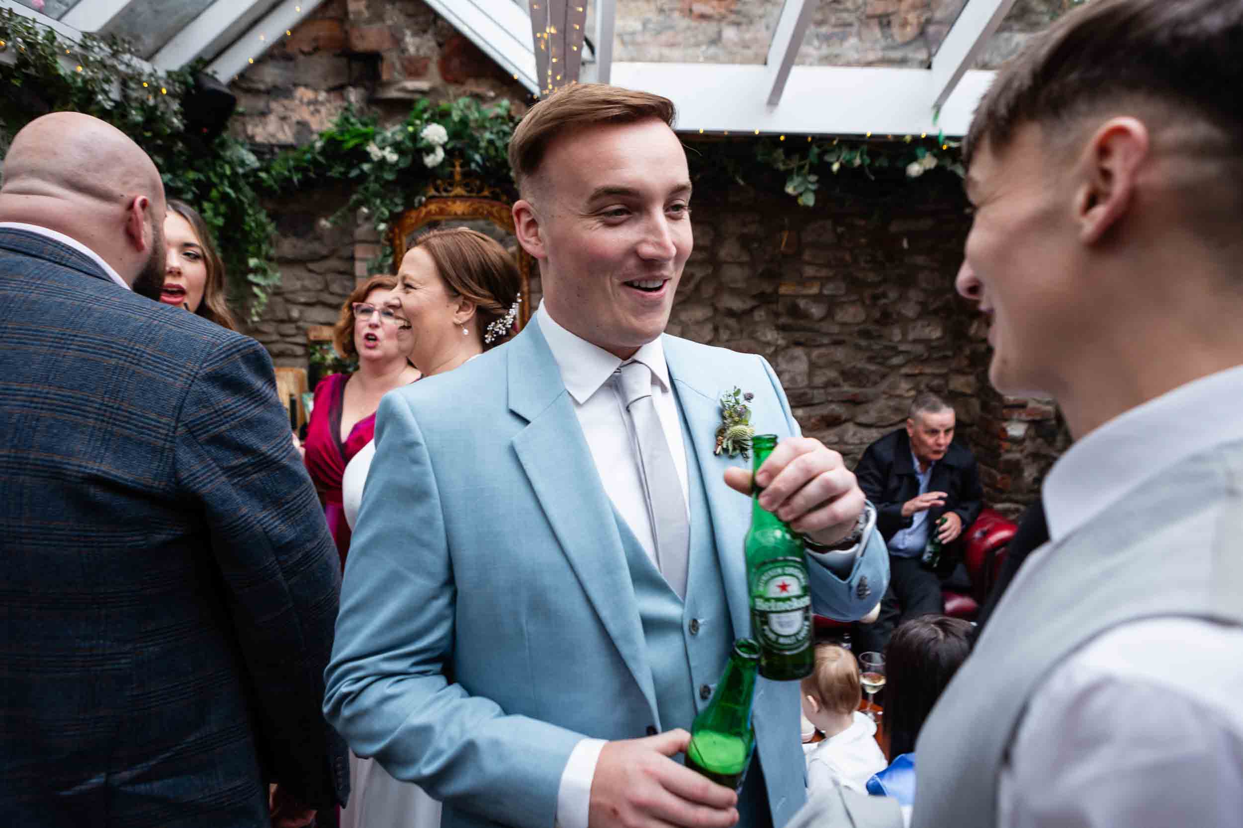 Guests chat during a wedding at the Radnor Rooms, Bristol.