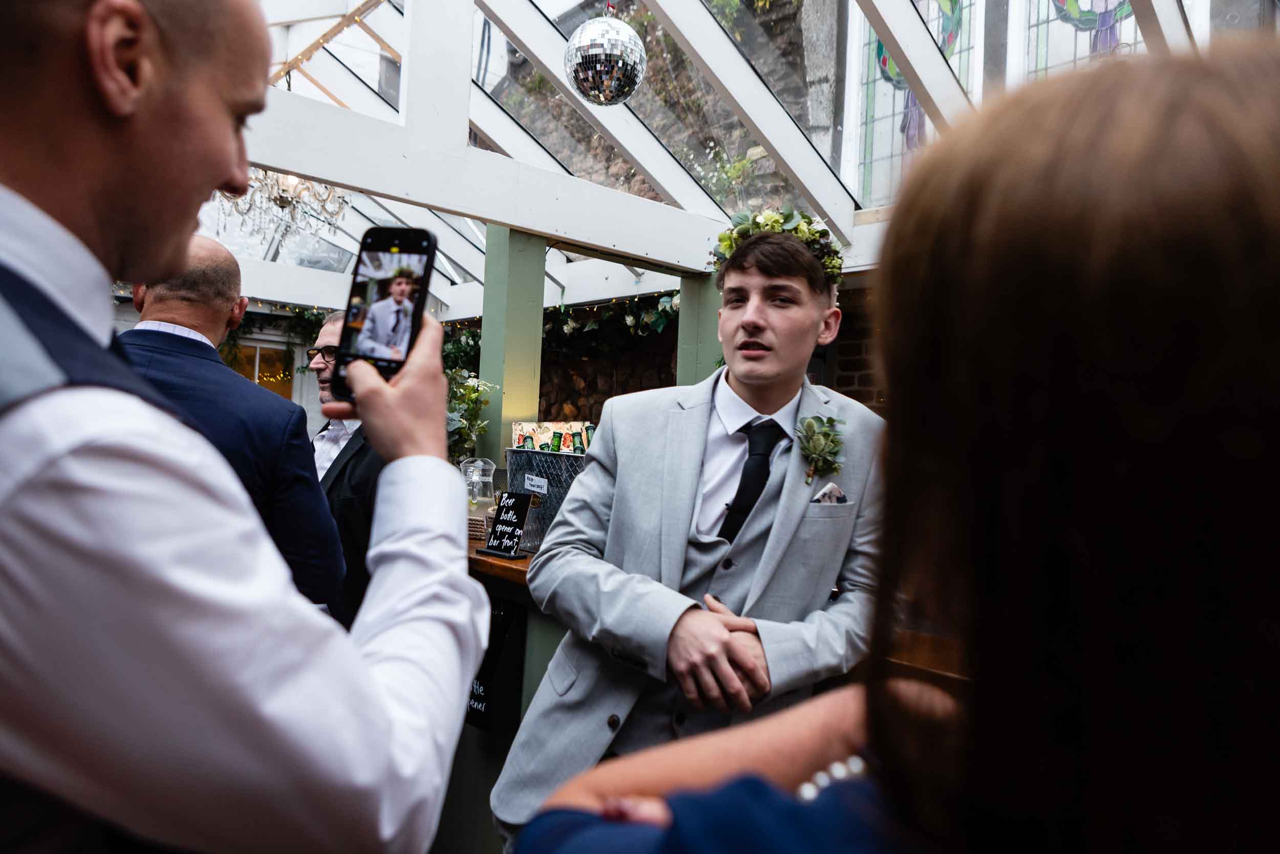 Guests take selfies during a wedding at The Radnor Rooms in Bristol.
