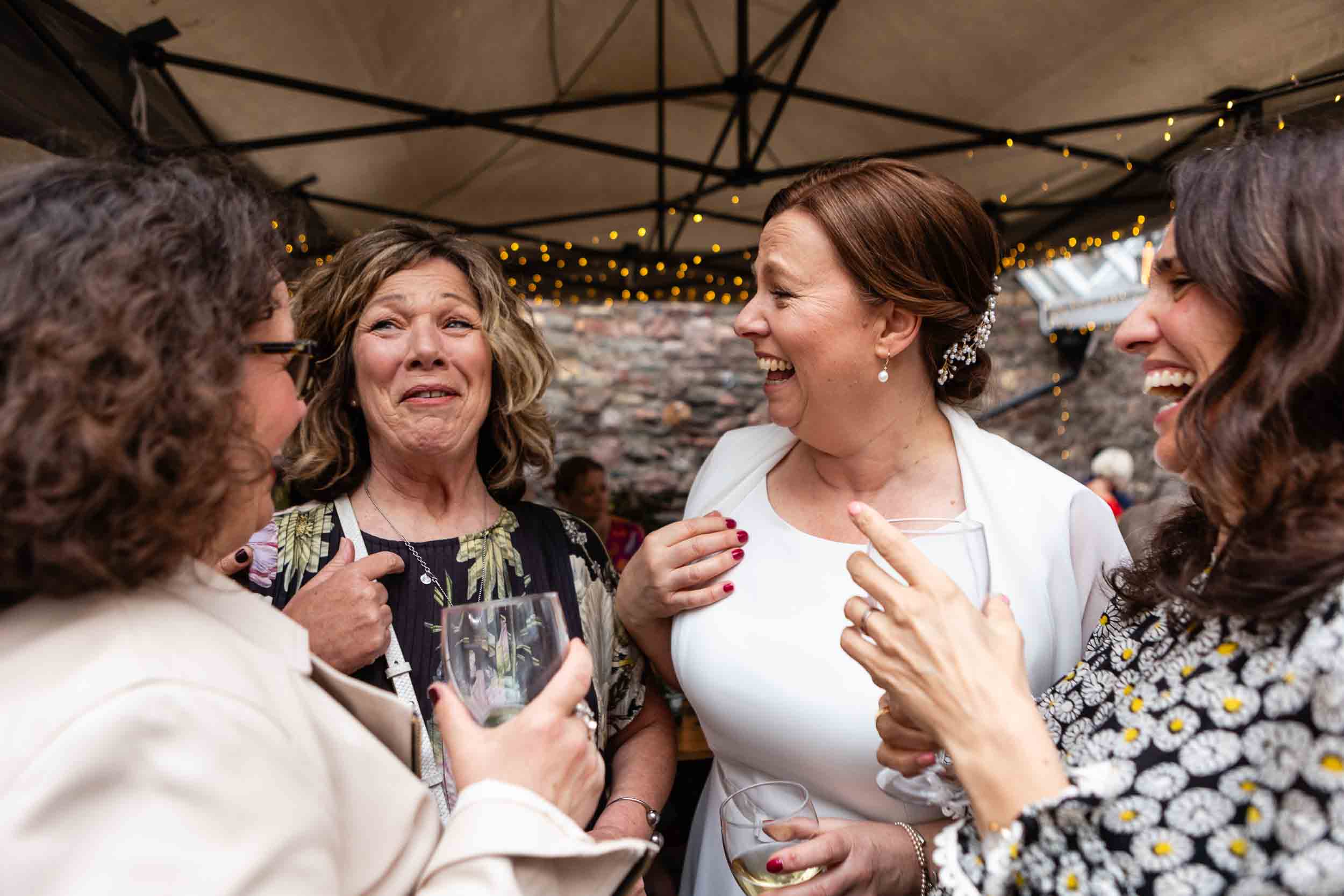 Guest laugh with the bride during a wedding at The Radnor Rooms, Bristol.