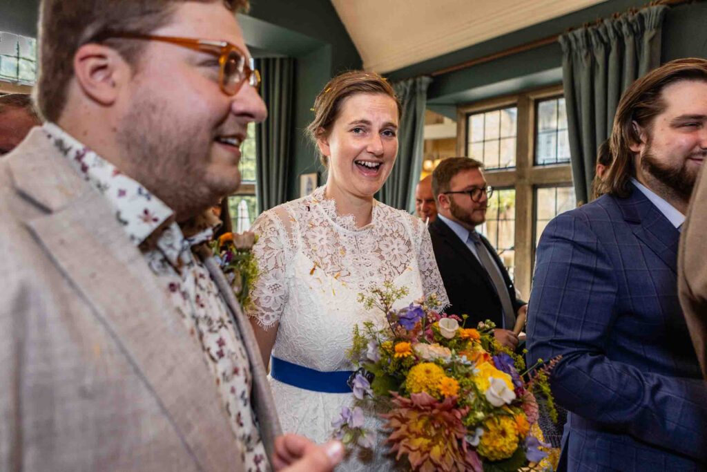 Bride looking happy at The Hare and Hounds, Tetbury | Wedding Photos