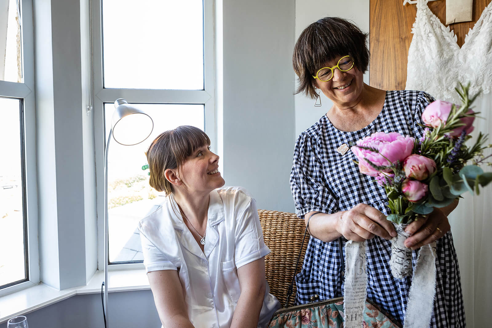 Bride and Mother-of-the-bride looking at flowers | Rose Dedman Beach Wedding Photography UK