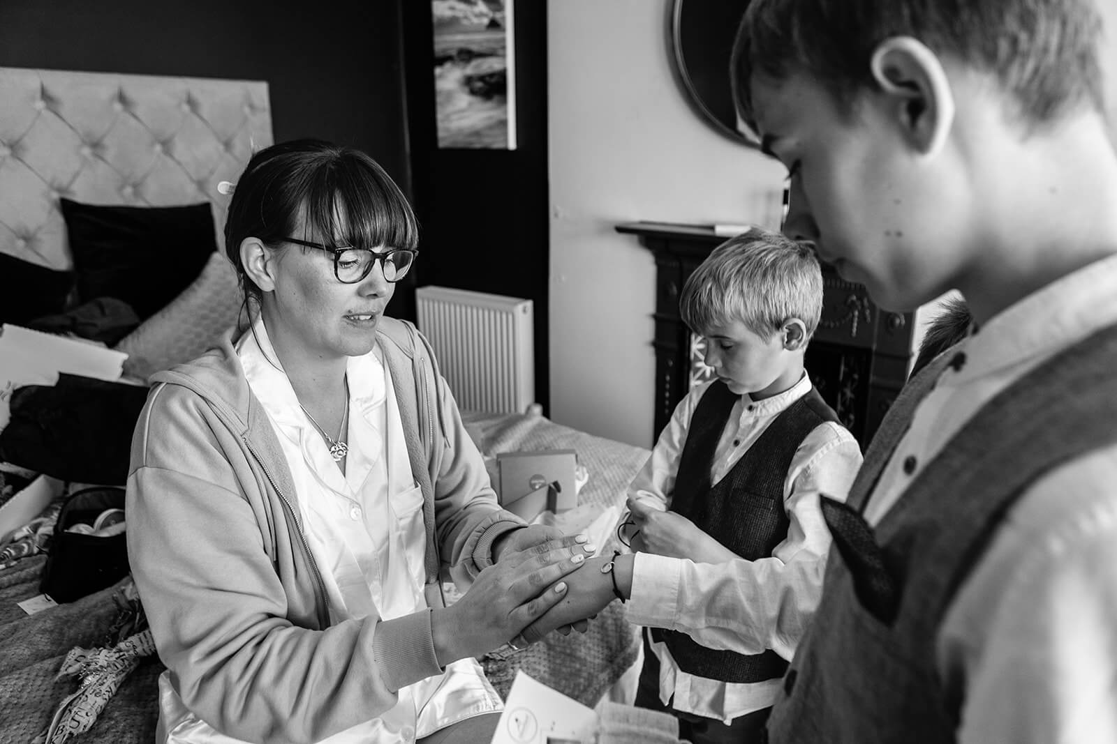 Bride giving her sons special bracelets | Rose Dedman Wedding Photographer UK