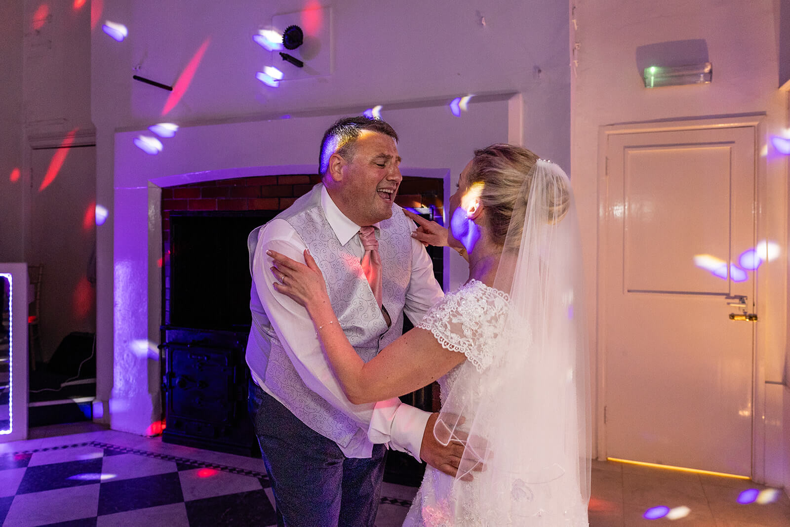 Bride and groom dancing at wedding reception. Holmewood Hall wedding photographer Rose Dedman.