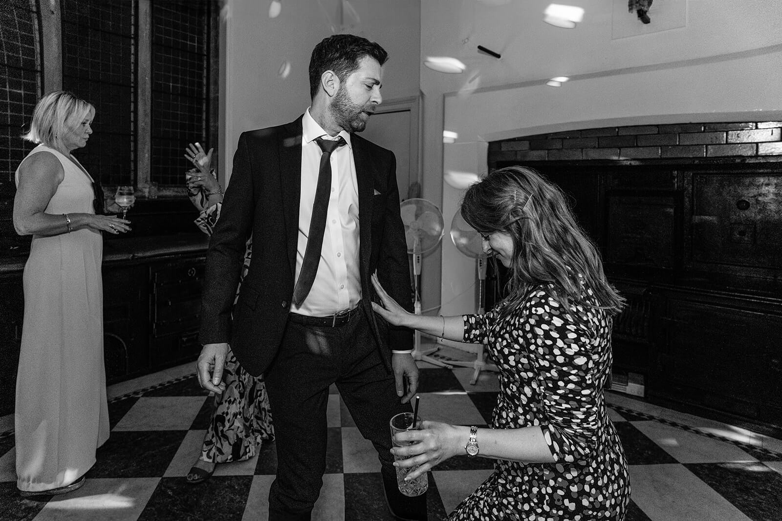 People dancing at a wedding party at Holmewood Hall, Cambridgeshire. Wedding Photographer Rose Dedman