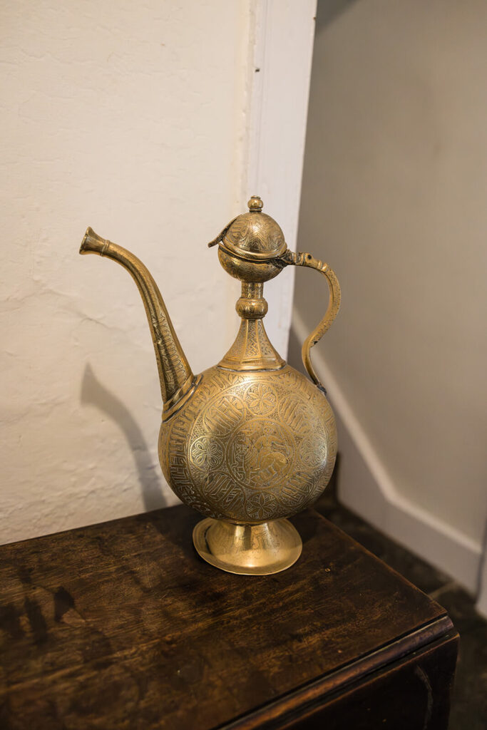 Antique brass teapot with intricate engravings at Pennard House wedding venue in Somerset, by UK wedding photographer Rose Dedman.
