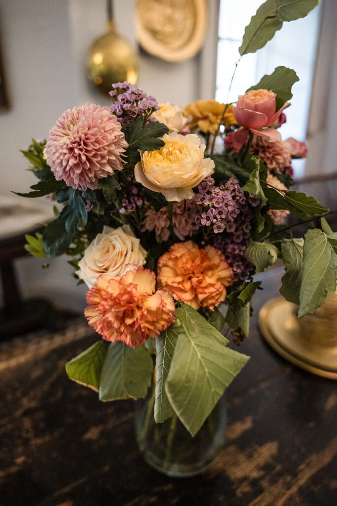 Colourful flower bouquet in a vase on table.