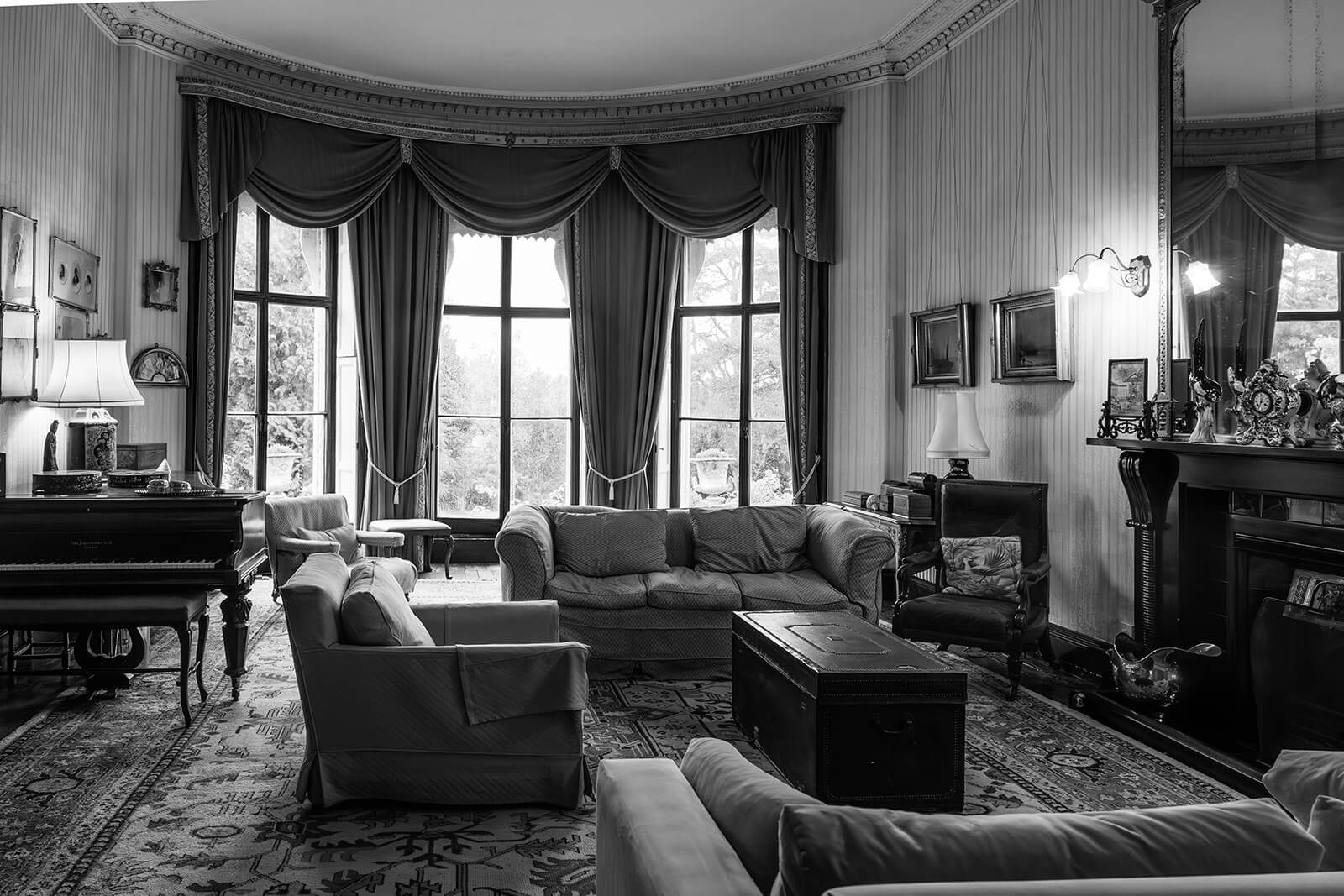 Elegant vintage living room with grand piano at Pennard House, by Pennard House wedding photographer Rose Dedman.
