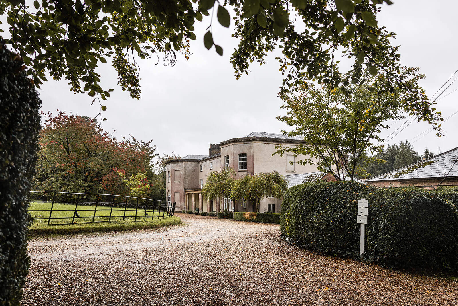 Pennard House historic wedding venue with autumn trees and gravel driveway. By Pennard House UK wedding photographer Rose Dedman.