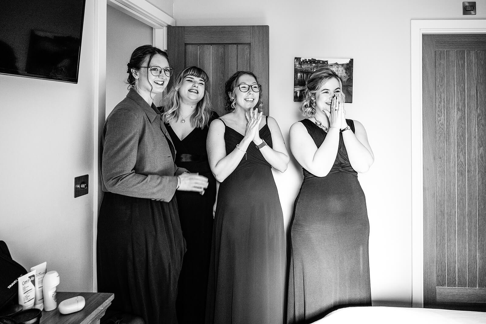 Four women smiling in anticipation or excitement | Wedding photographer | Bath Mill Lodges
