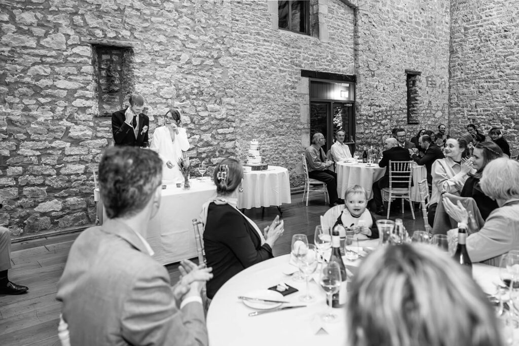 Wedding reception with guests applauding | Priston Mill wedding photographer