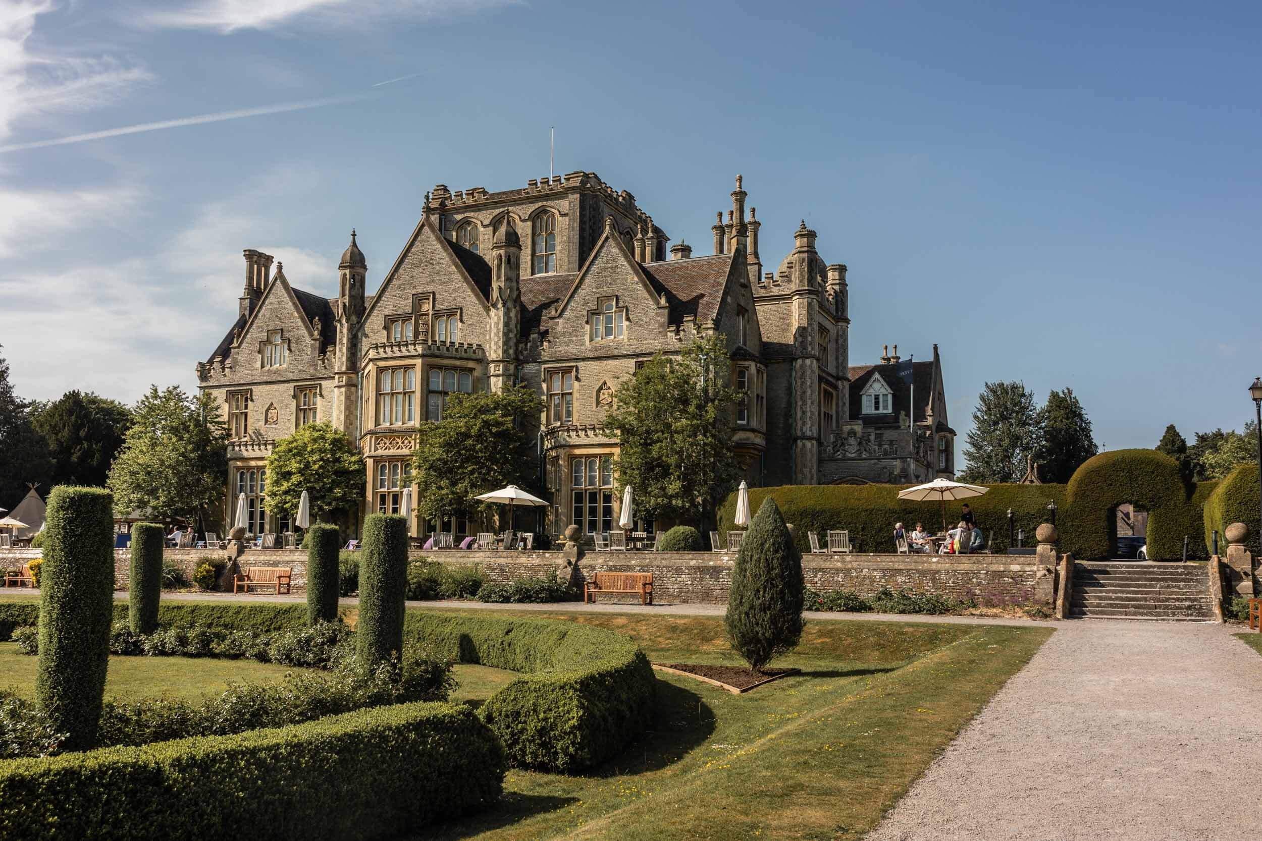Tortworth Court exterior view from the landscaped gardens on sunny day | Tortworth Court Wedding Photographer