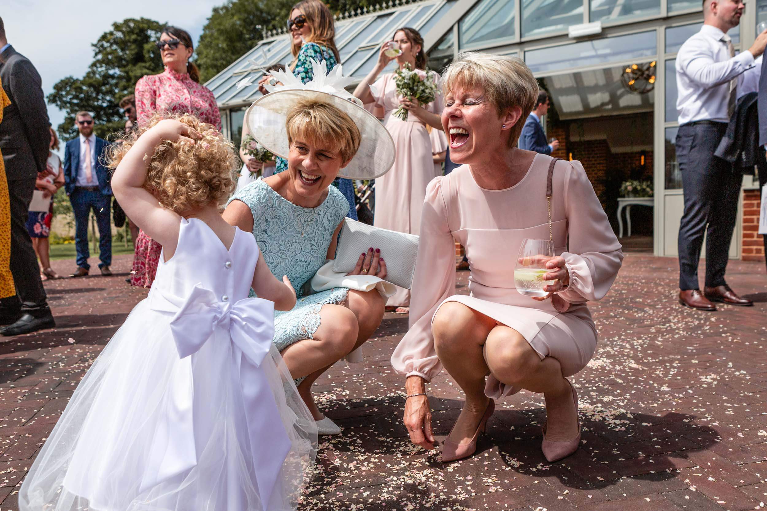 Smiling women and a child at an outdoor wedding celebration at Syrencot House.