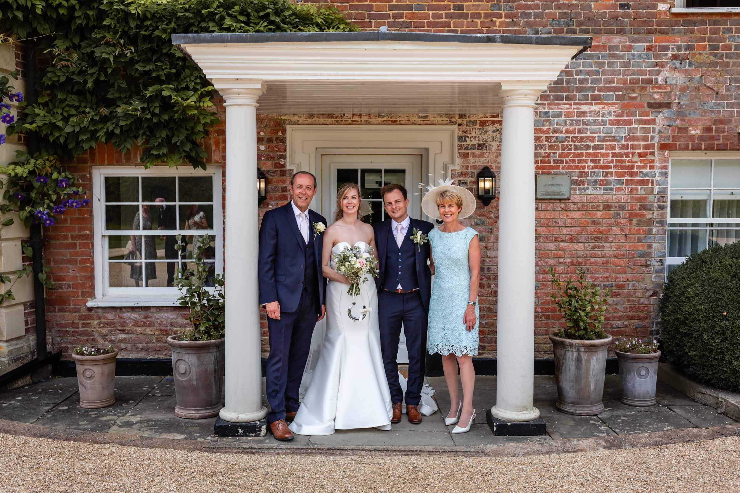 Wedding couple with parents outside Syrencot House