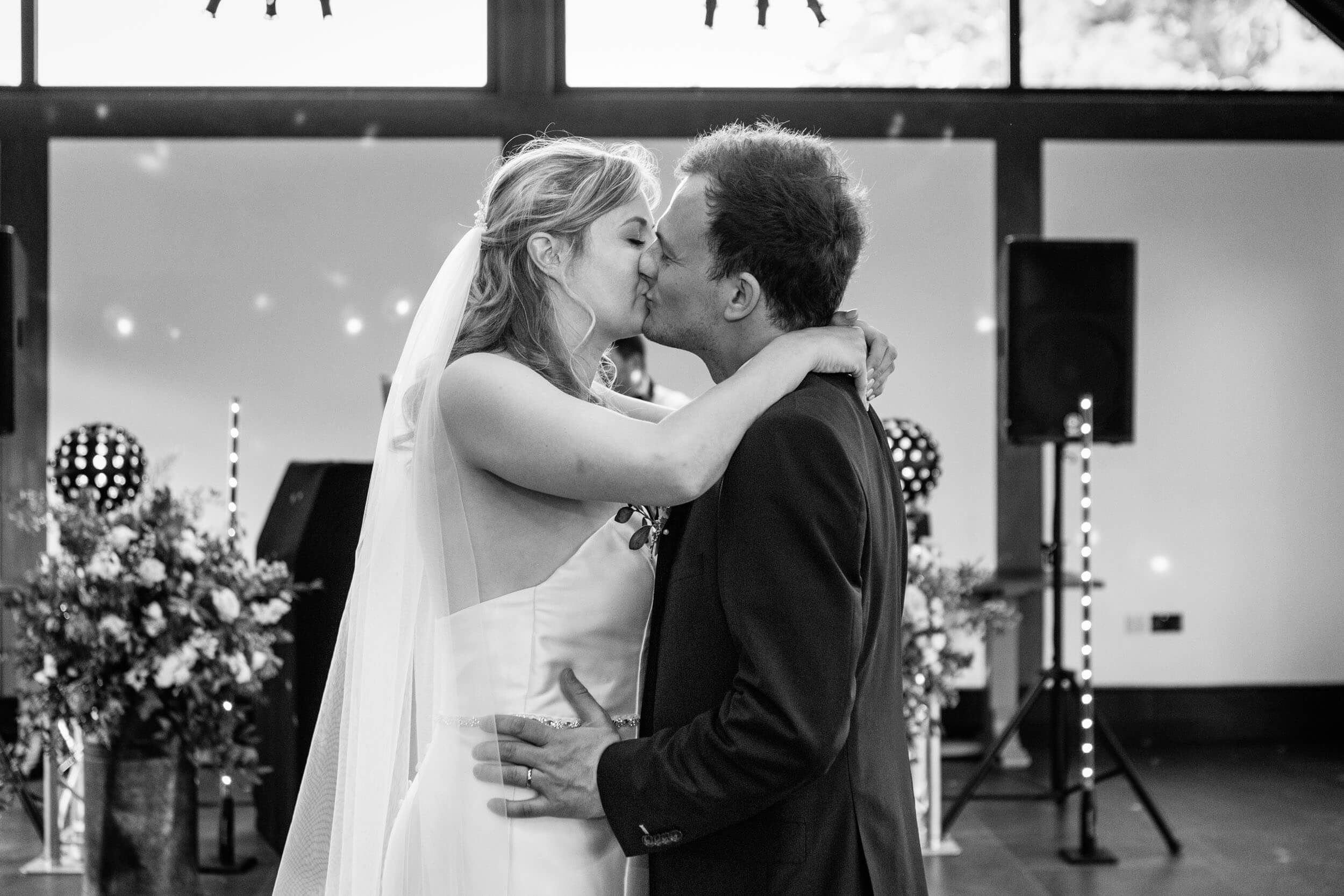 Newlyweds kissing at wedding evening party at Syrencot House | Syrencot wedding photographer.