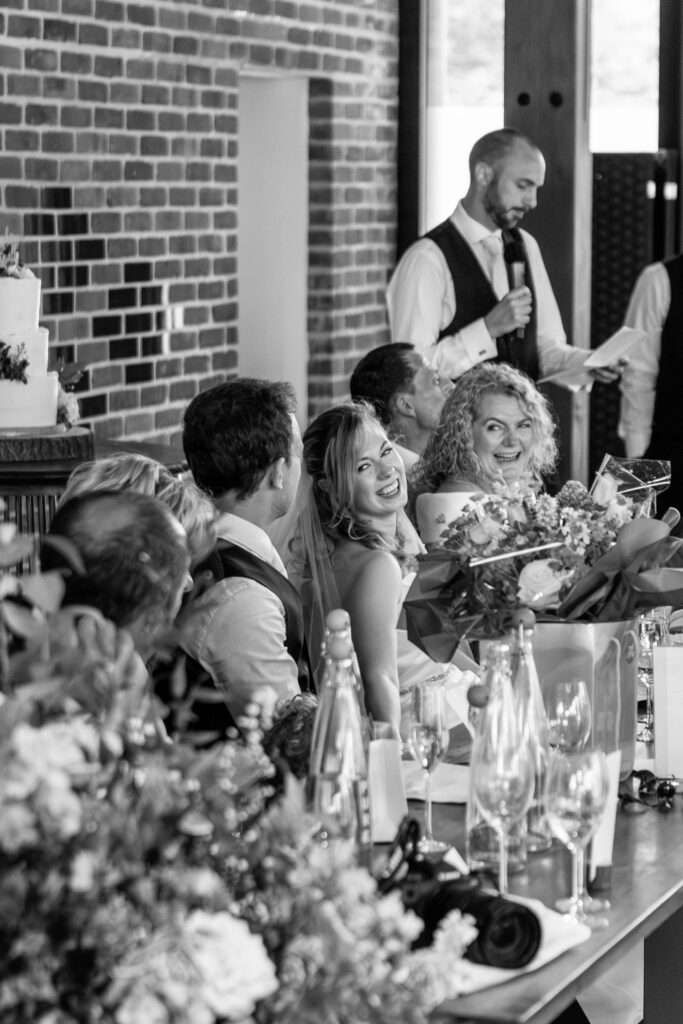 Wedding speech with laughing bride and guests at Syrencot House | Syrencot House wedding Photography
