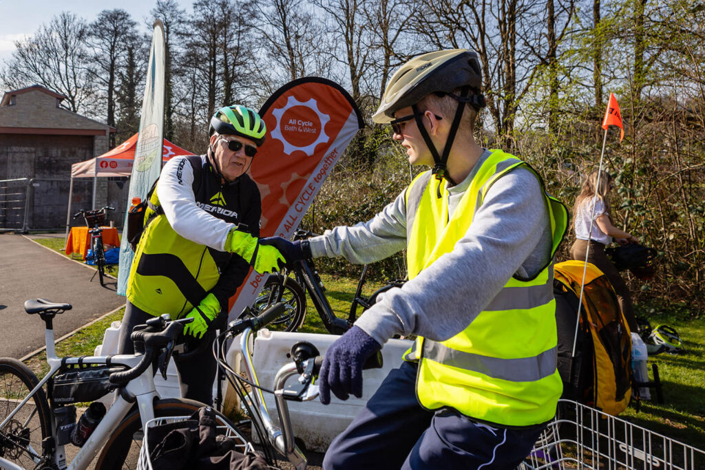 Cyclists conversing at a park event