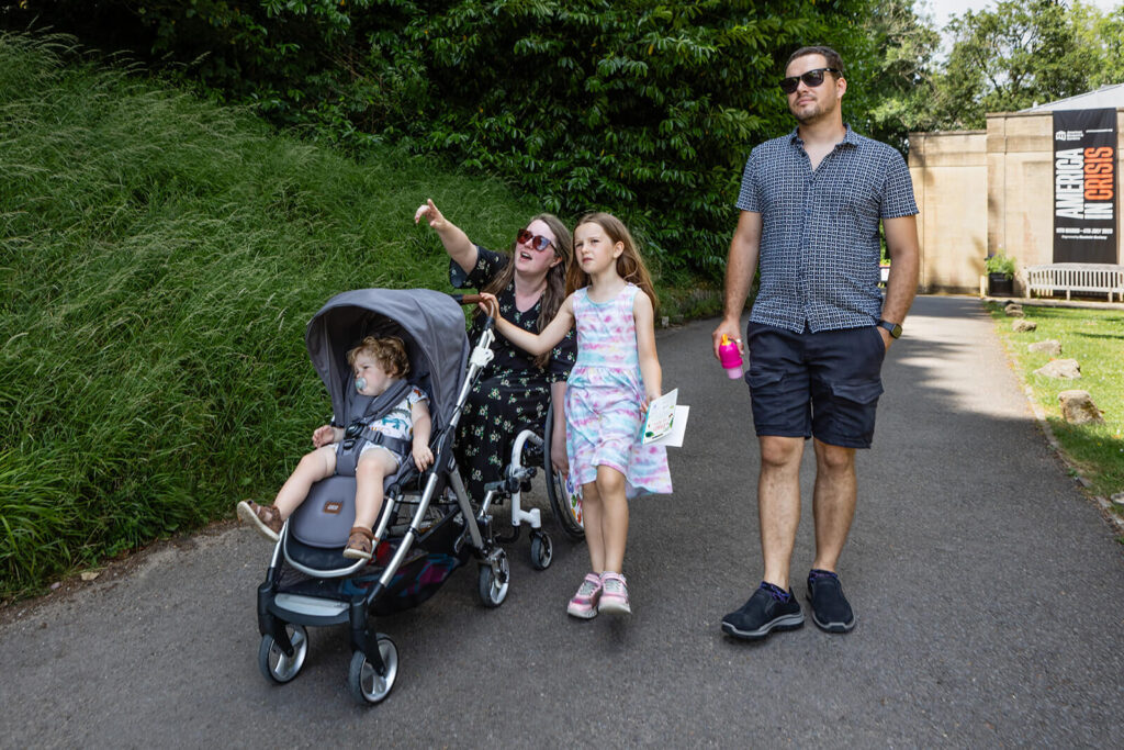 Family strolling through a park pathway