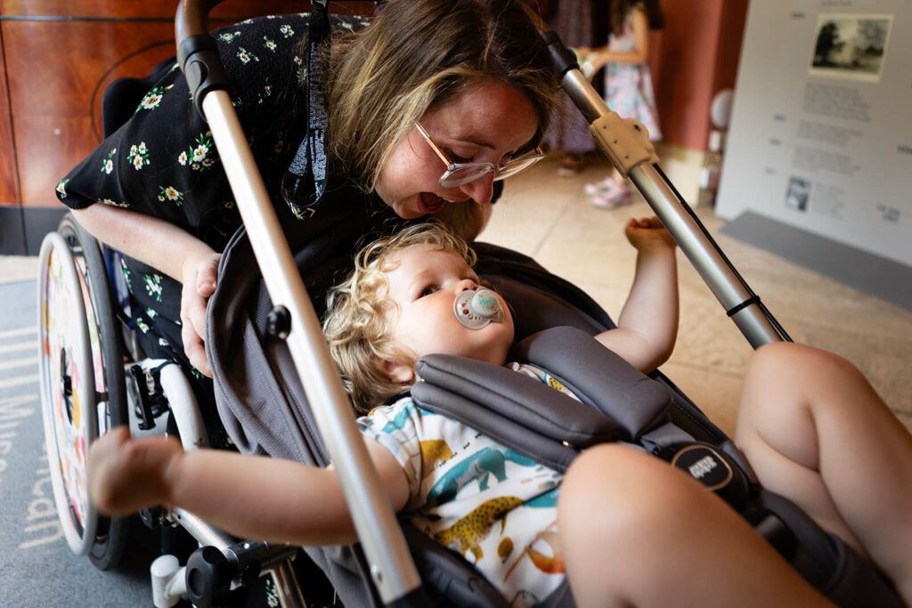 Woman with child in wheelchair stroller