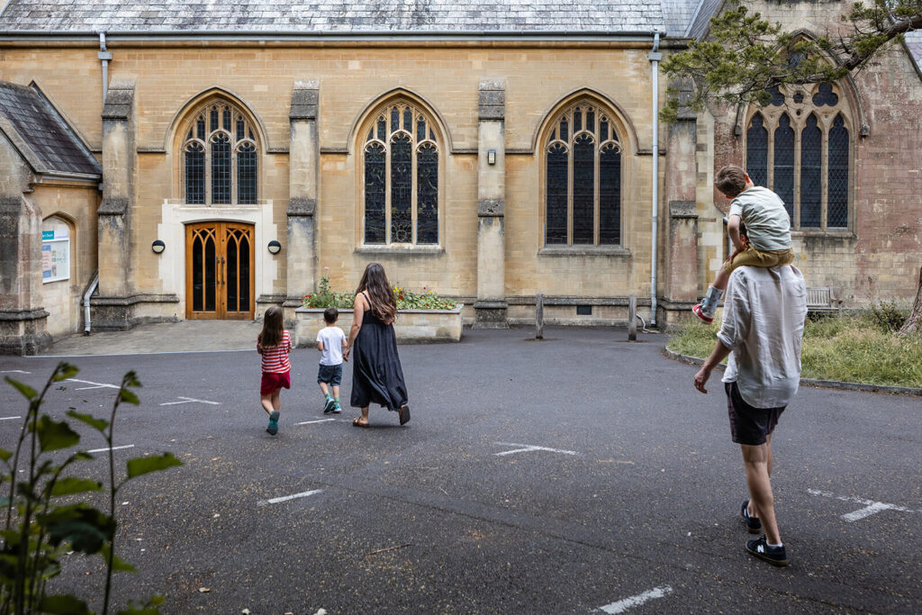 Family walking towards historic church entrance