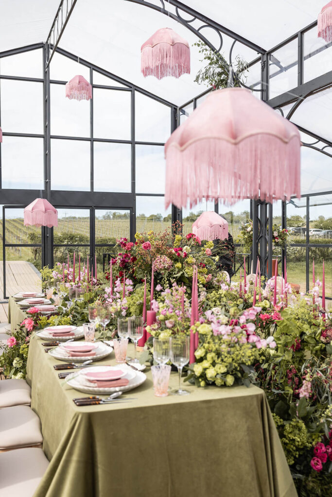 Elegant floral dining setup in greenhouse