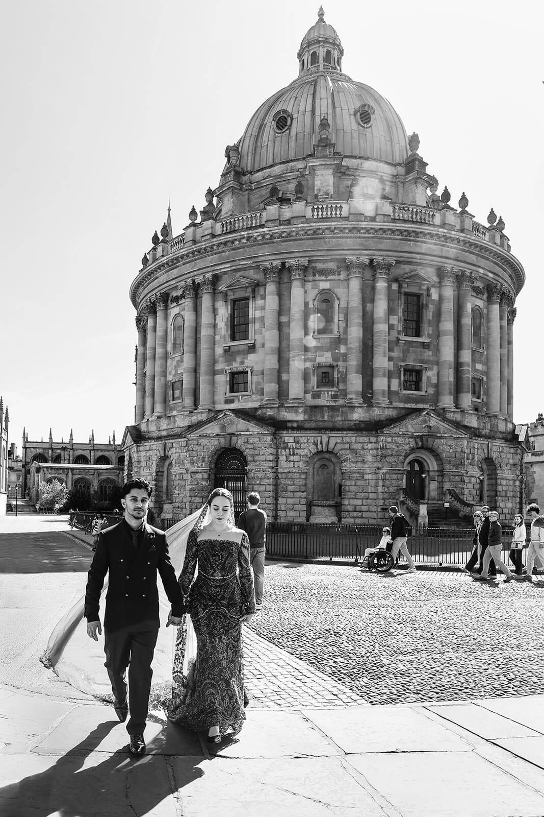 Bride and groom walking in front of The Radcliffe Camera in central Oxford | Oxford Nikkah wedding photographer