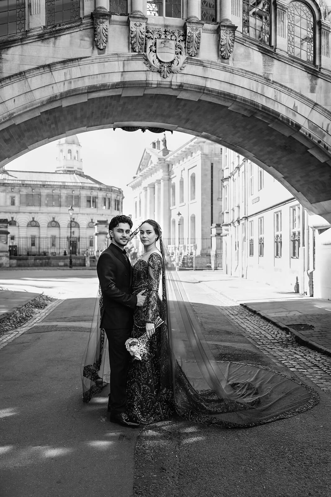 Elegant couple under the Bridge of Sighs in central Oxford | Nikkah wedding photographer UK