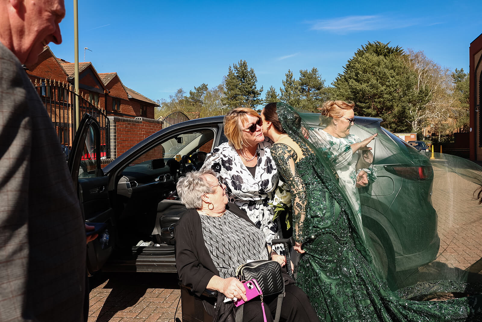 Bride in green gown greeting family members before her Nikkah ceremony in Oxford