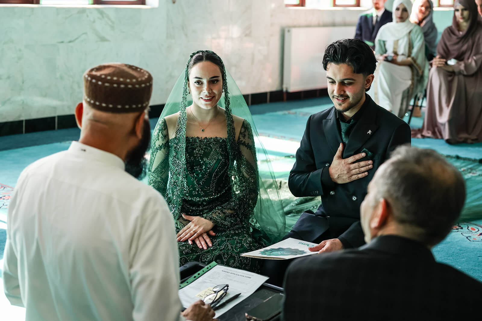 Couple in traditional Nikkah wedding ceremony in Oxford Central Mosque with officials