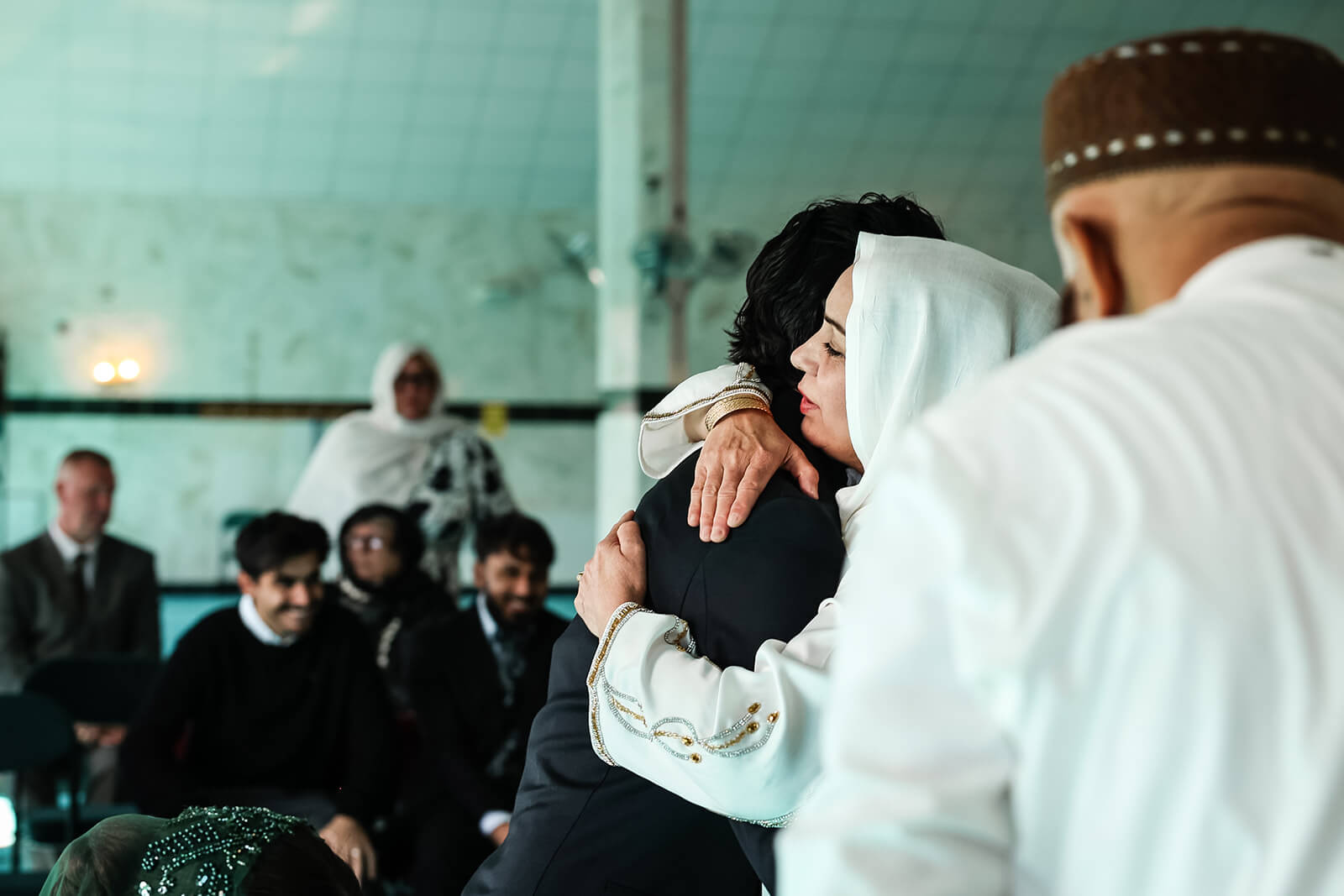 People embracing after a Nikkah ceremony in Oxford Central Mosque