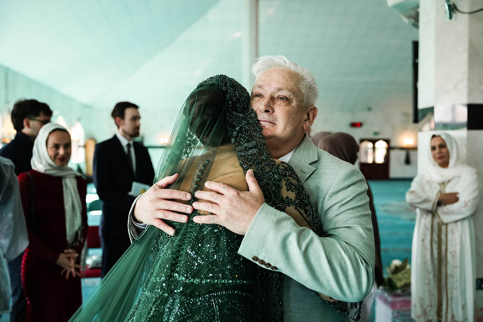 Emotional hug at a joyful Nikkah wedding ceremony with family blessing at Oxford Central Mosque