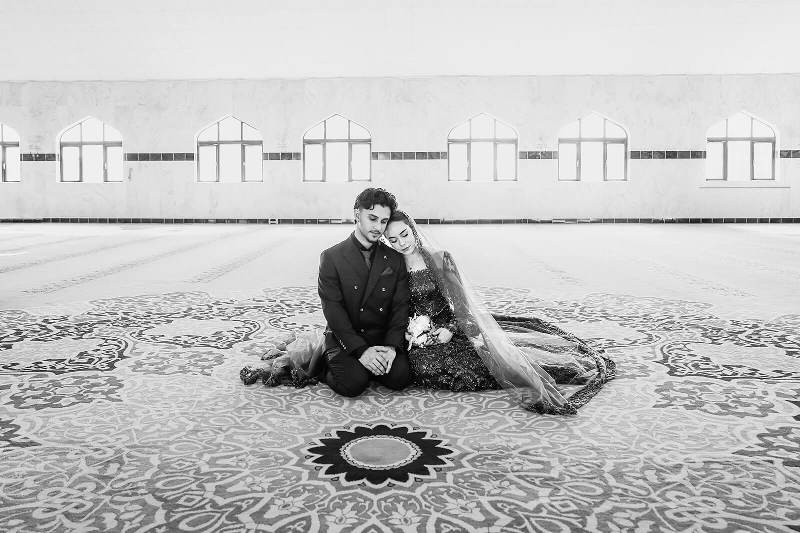 Bride and groom couple sitting in ornate mosque interior at Oxford Central Mosque