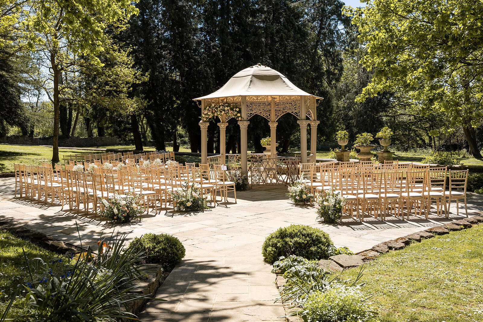 Outdoor wedding gazebo with chairs in garden set up for an Eastington Park outdoor wedding | Eastington Park wedding photographer.